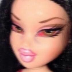 a close up of a doll with long black hair and pink eyeshadow on it's face