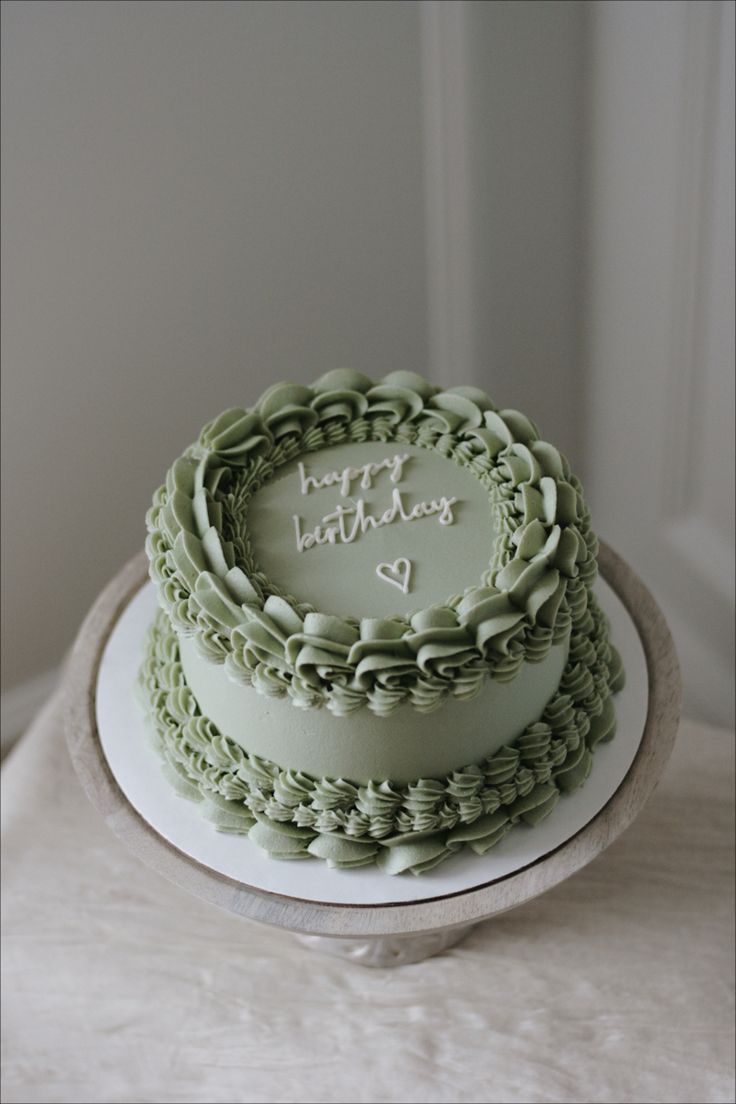 a birthday cake sitting on top of a white table next to a window with the words happy birthday written on it