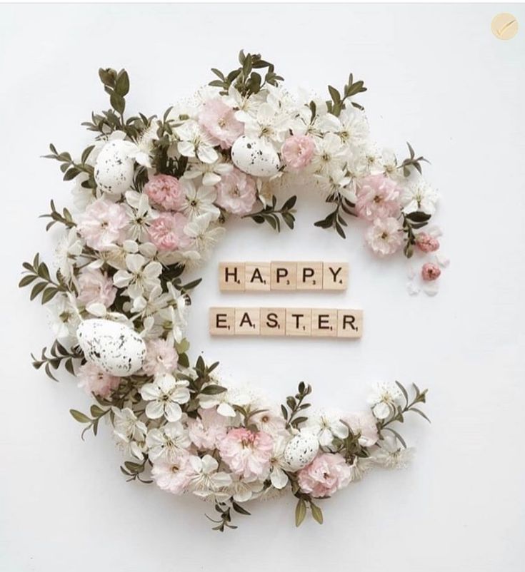 an easter wreath made out of wooden letters and flowers