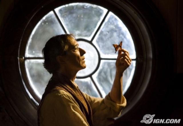 a man holding something in front of a round window