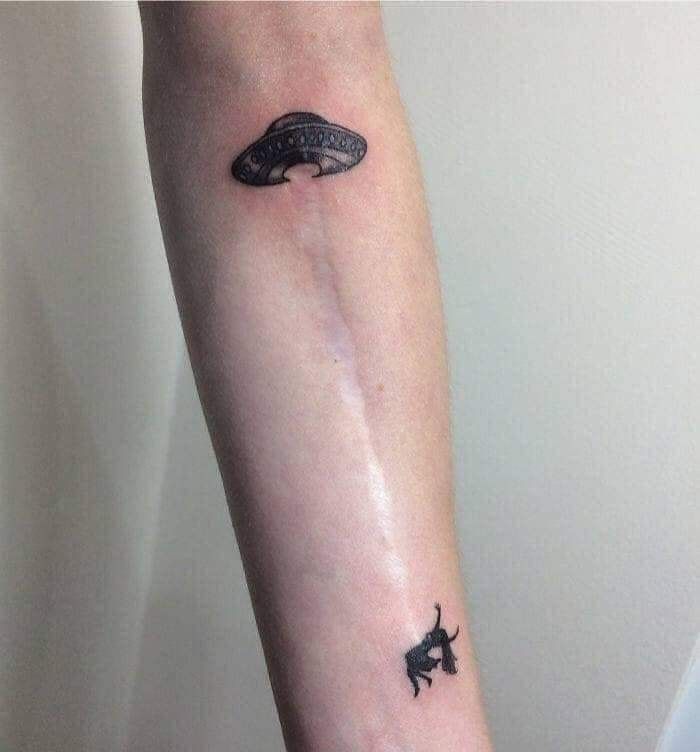 a small whale tattoo on the arm