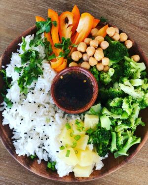 a plate with rice, broccoli, carrots and chickpeas on it