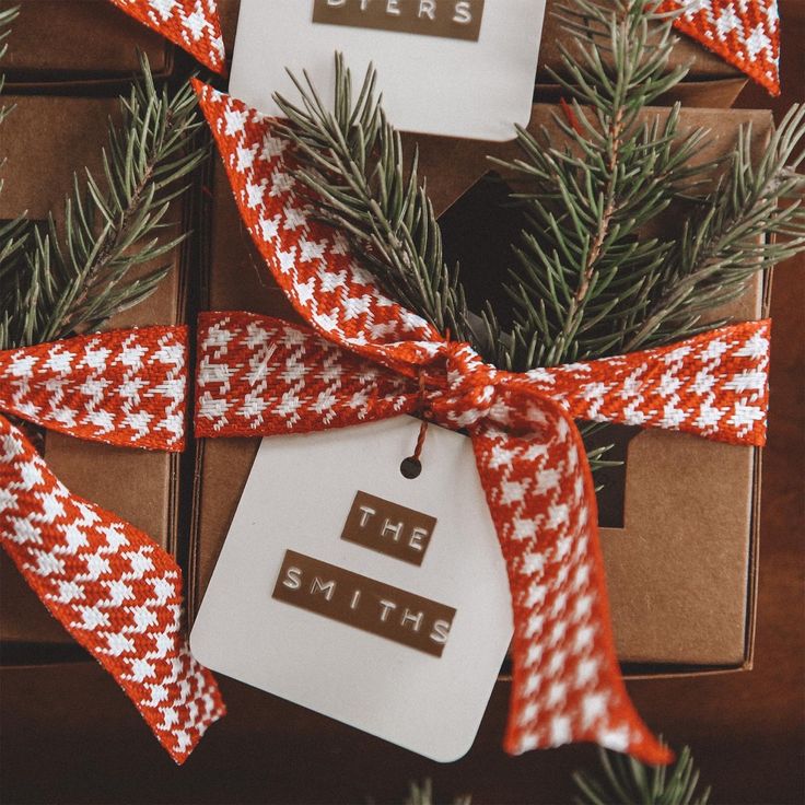 christmas presents wrapped in red and white checkered ribbon with the words, the smith on them