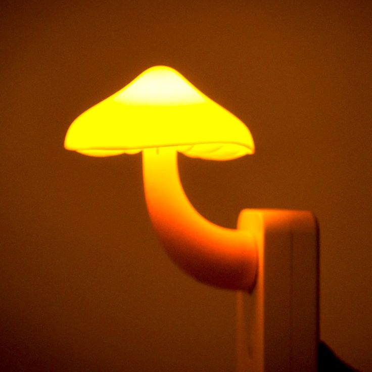 a yellow mushroom lamp sitting on top of a table