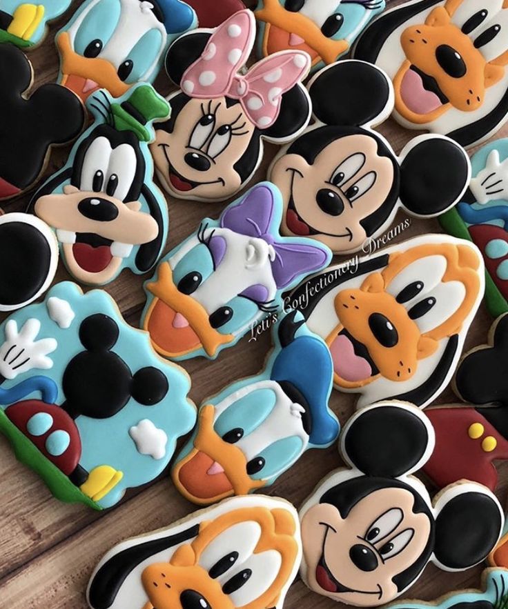 mickey and minnie mouse cookies on a table