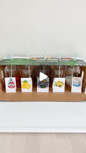 an open box with several different types of drinks in it on top of a table