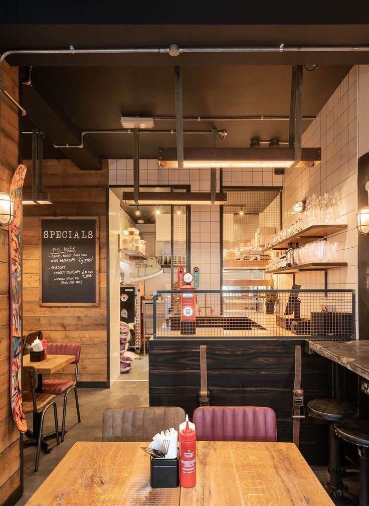 the inside of a restaurant with wooden tables and chairs