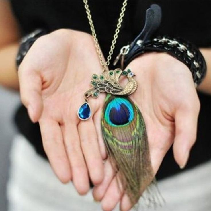 Designed with exotic color and feel, this stunning Peacock Feather Pendant is a beautiful piece that adds character and flare to any outfit. The added texture of the feather itself is complimented by a vibrant dangling crystal, making this a truly rare statement piece that is sure to get everyone's attention. This pendant would make a great gift for your treasured ones on any special occasion. We truly believe we make some of the most innovative products in the world, and we want to make sure we Peacock Feather Pendant, Necklaces Unique, Feather Pendant Necklace, Peacock Necklace, Pocket Watch Necklace, Sapphire Necklace Pendants, Peacock Pendant, Cheap Necklaces, Accesories Jewelry