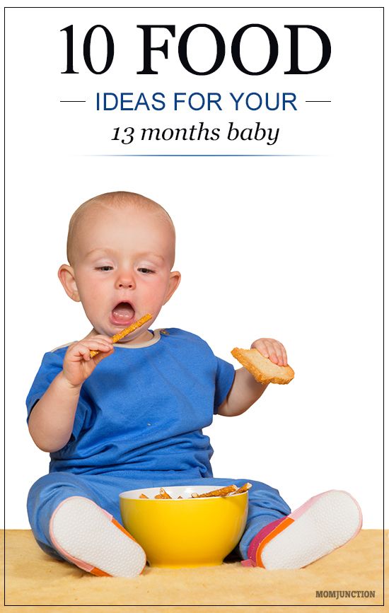 a baby sitting on the floor eating food from a yellow bowl and holding a spoon