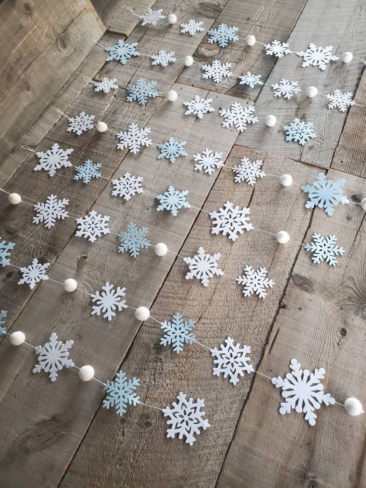 snowflakes are laid out on the wooden floor