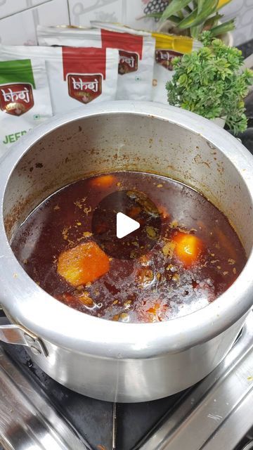 a pot filled with soup sitting on top of a stove next to boxes of food