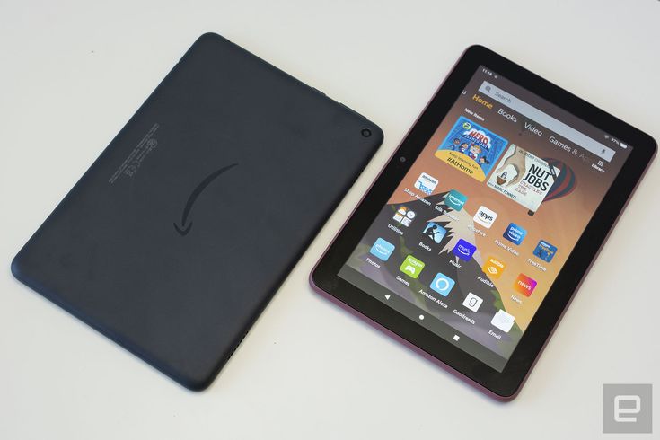 an ipad and tablet sitting next to each other on a white counter top with the cover open