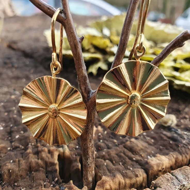 "The SunChild These earrings are gold-plated, and made by hand in our traditional workshops. The circular fan is struck by hand in the old fashioned way as fitting of our heritage as a \"Mint\". The tiny face of a child in the centre is struck by hand using a steel die made from one of our ancient hand punches, of which we have a vast collection.  Simply a stunning piece of jewellery - the multi-faceted face catches the light in all directions." Brass Medallion Earrings As A Gift, Adjustable Antique Gold Earrings, Heirloom Gold Earrings For Gift, Antique Brass Earrings, Gold Round Disc Earrings For Pierced Ears, Yellow Gold Round Disc Earrings For Gift, Antique Gold Round Earrings, Heirloom Style Hallmarked Brass Earrings, Handmade Antique Yellow Gold Earrings