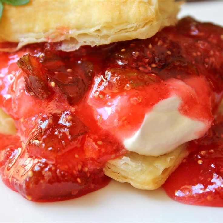 a close up of a sandwich on a plate with ketchup and cream cheese