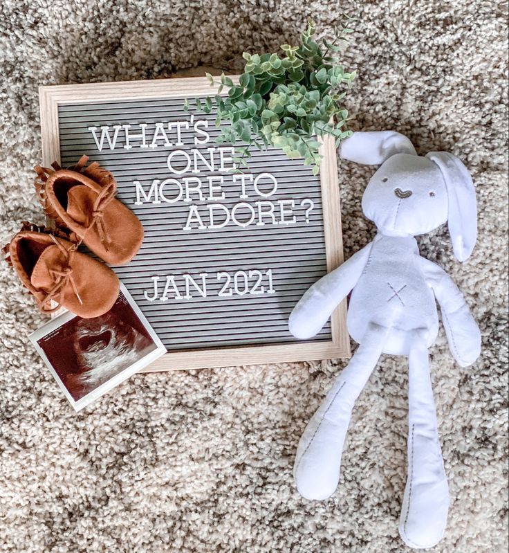 a stuffed animal next to a sign that says what's one more to adore?