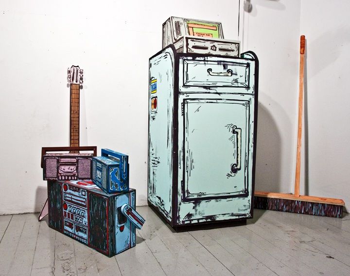 two old refrigerators sitting next to each other on the floor in front of a white wall