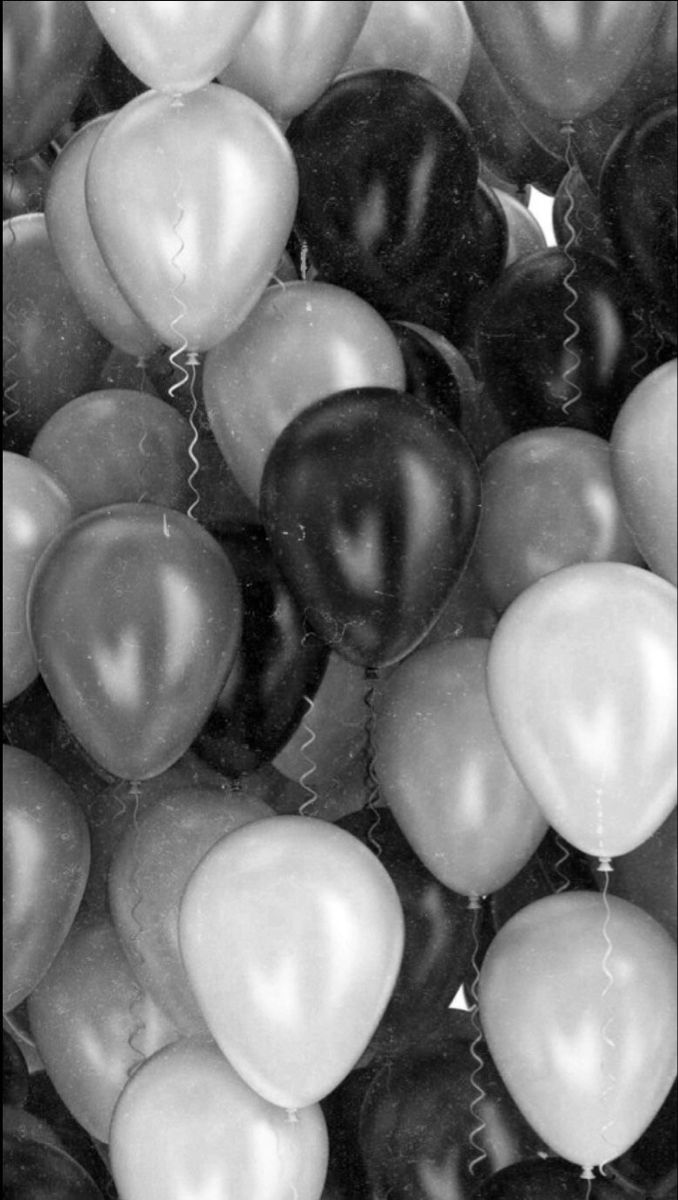 black and white photograph of balloons in the shape of heart - shaped shapes with string