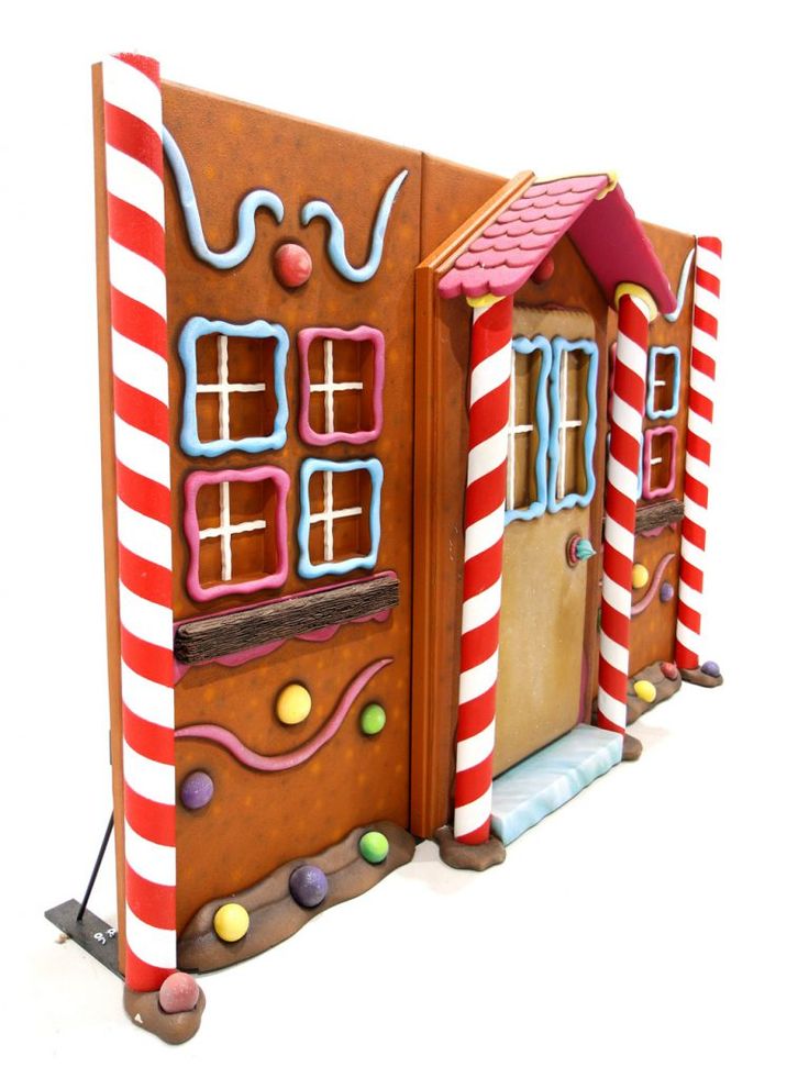 a gingerbread house made out of cardboard with candy and candies on the outside