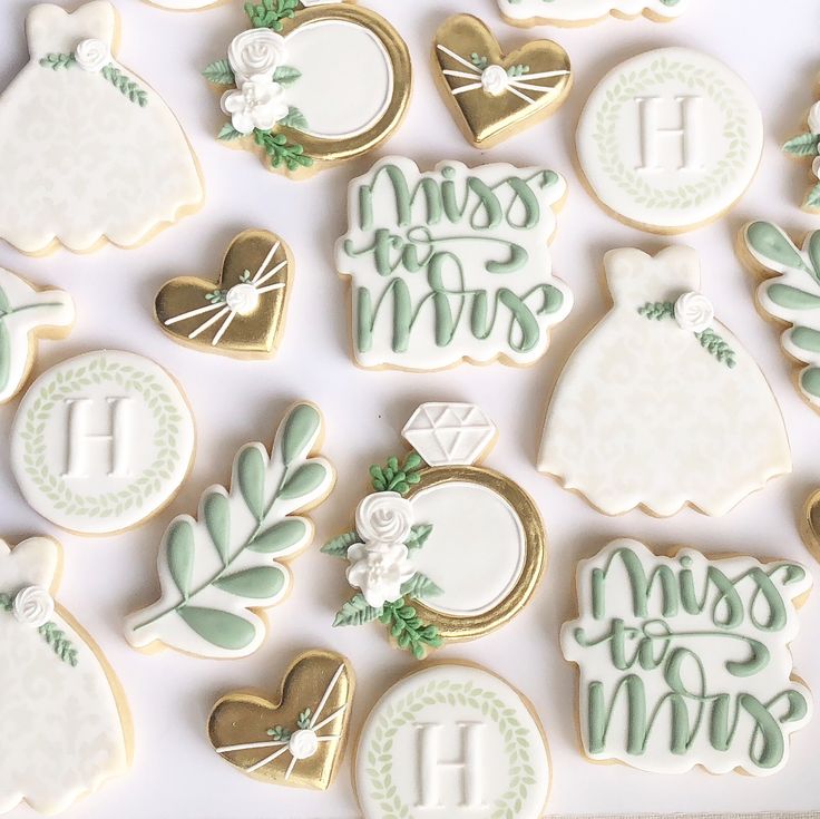 decorated cookies are arranged in the shape of bride and groom's dresses, with monogrammings on them