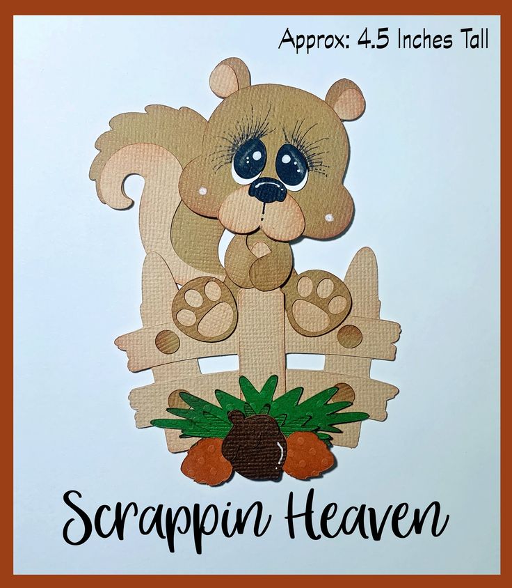 a brown teddy bear sitting on top of a wooden sign that says scrappin heaven