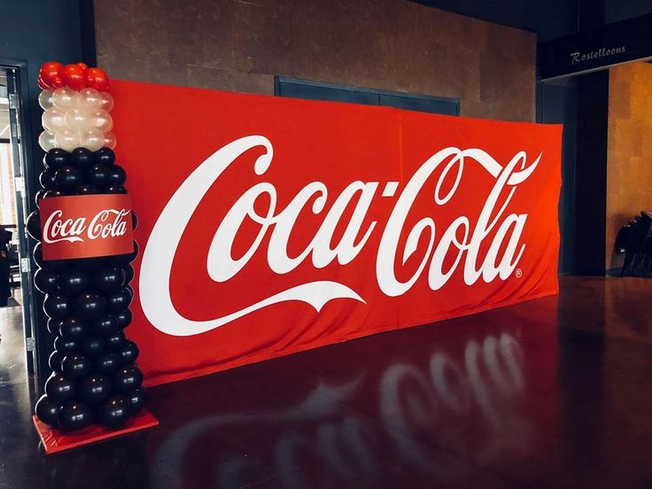 a coca - cola sign is displayed on a table