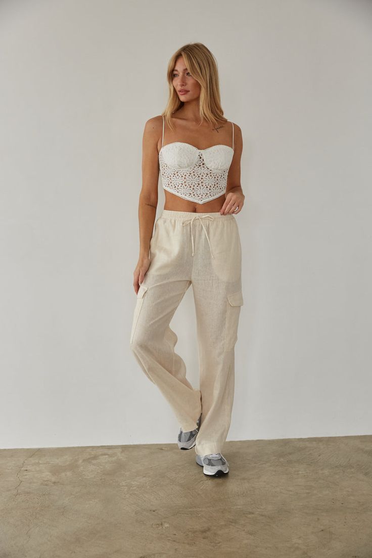 Get ready for a weekend getaway in the Vienna Linen Cargo Pants! These wide leg pants feature double front pockets, two cargo-style leg pockets, and an elastic waistband with an adjustable drawstring. Available in white and linen. Pair with the Mae Lace Crop Top to complete the look! Details 55% Linen, 45% Viscose High rise Dry clean only Linen Cargo Pants, American Threads, Cargo Style, Ruffled Maxi Dress, Lace Crop Tops, Lace Ruffle, Sweater Sale, Weekend Getaway, Beach Days