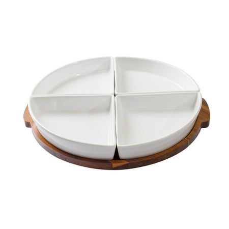 a white plate with four sections in it on a wooden platter, against a white background