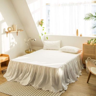 there is a bed with white sheets in the room