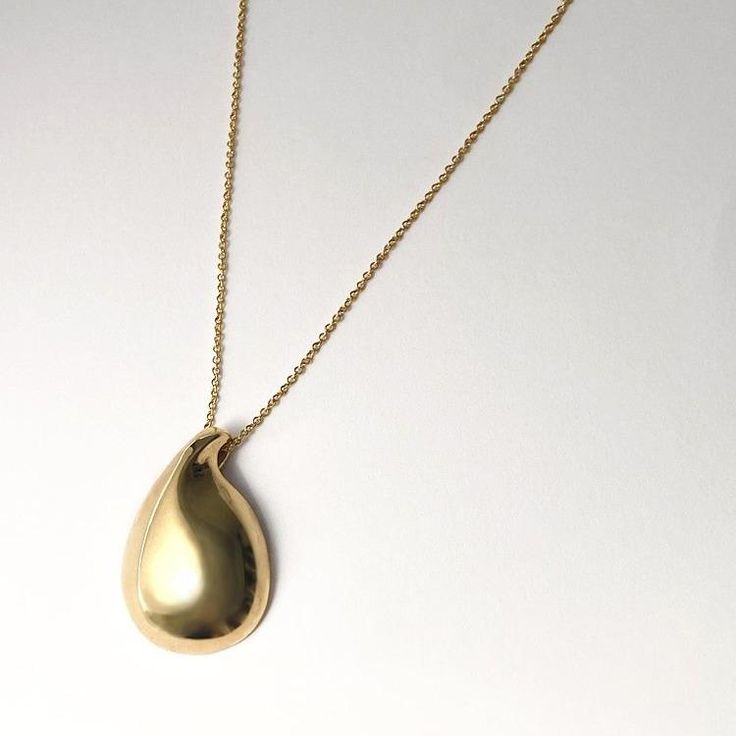 Designer Notes + Modern and elegant hand carved water drop pendant necklace that works as your everyday statement piece. DETAILS + •Color/ Material: Gold / 18K yellow gold plated brass, 3 micron electroplating. Silver/ high polished sterling silver. •Adjustable , 17 - 19" gold filled chain. • Care: Keep airtight (concealed) to maintain color and shine. Shipping + We ship worldwide. Orders start shipping in 3 to 4 weeks. Complimentary shipping within United States of America. All International or Luxury Teardrop Drop Necklace For Gift, Modern Gold Teardrop Pendant, Modern Long Drop Yellow Gold Earrings, Teardrop Pendant Necklace With Polished Finish, Gold Plated Teardrop Drop Necklace, Gold Teardrop Necklace With Detachable Pendant, Gold Plated Drop Necklaces For Formal Occasions, Formal Drop Necklace With Polished Finish, Formal Gold Plated Drop Necklaces