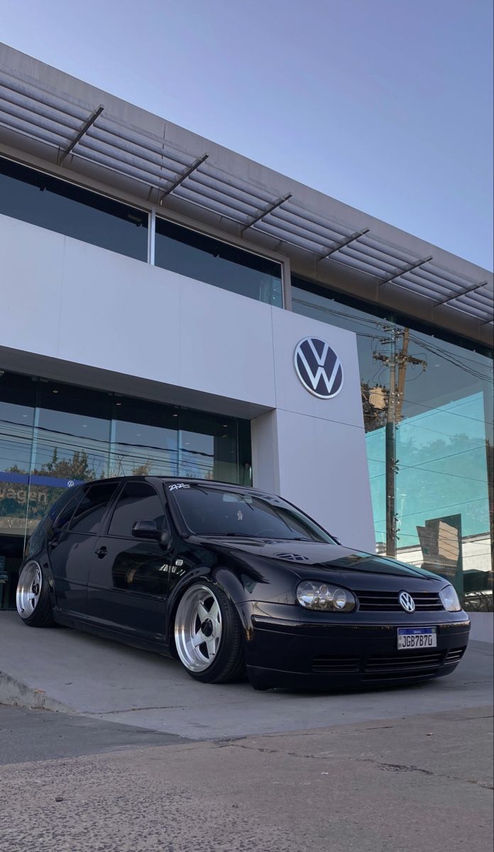 a black car parked in front of a building