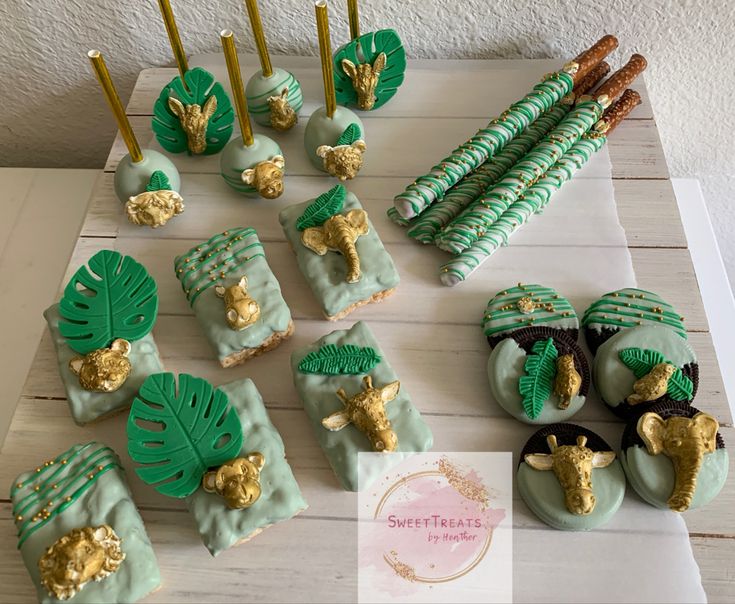 green and gold desserts are arranged on a table