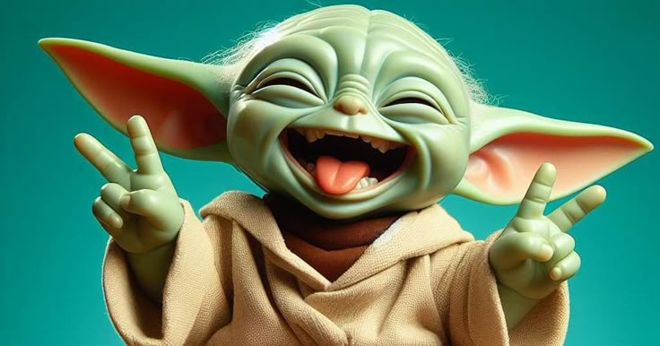 a star wars yoda action figure is smiling and holding his hands up in the air