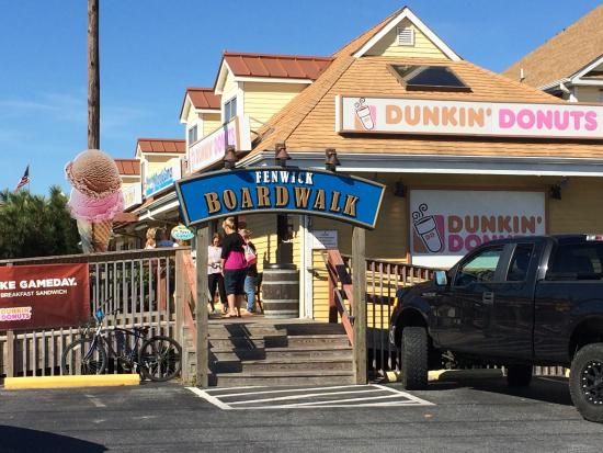 the entrance to dunkin'donuts with two women walking up it