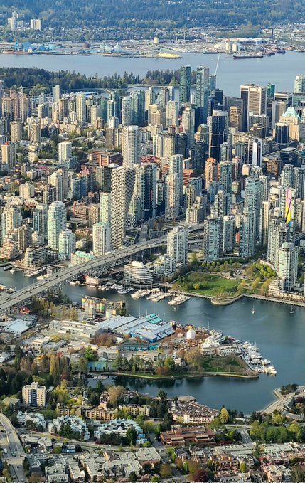 an aerial view of a large city with lots of tall buildings in the middle of it