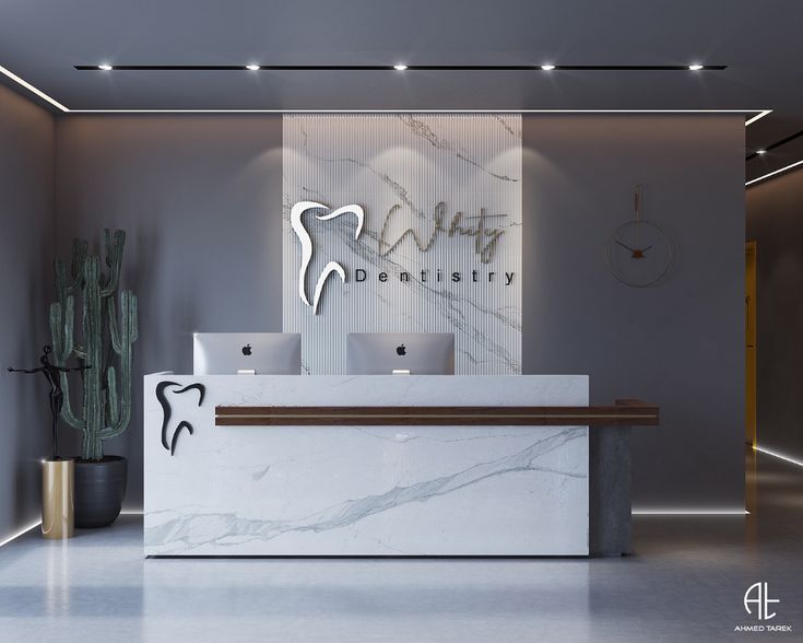 the front desk of a dental office with a marble reception counter and cactus in the background