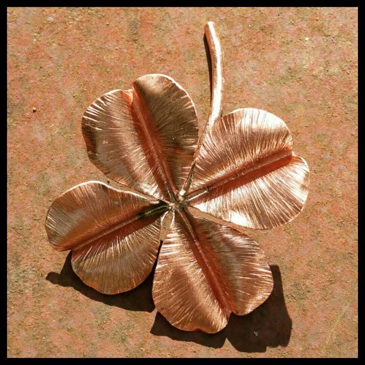 a four - leafed metal object is laying on the ground