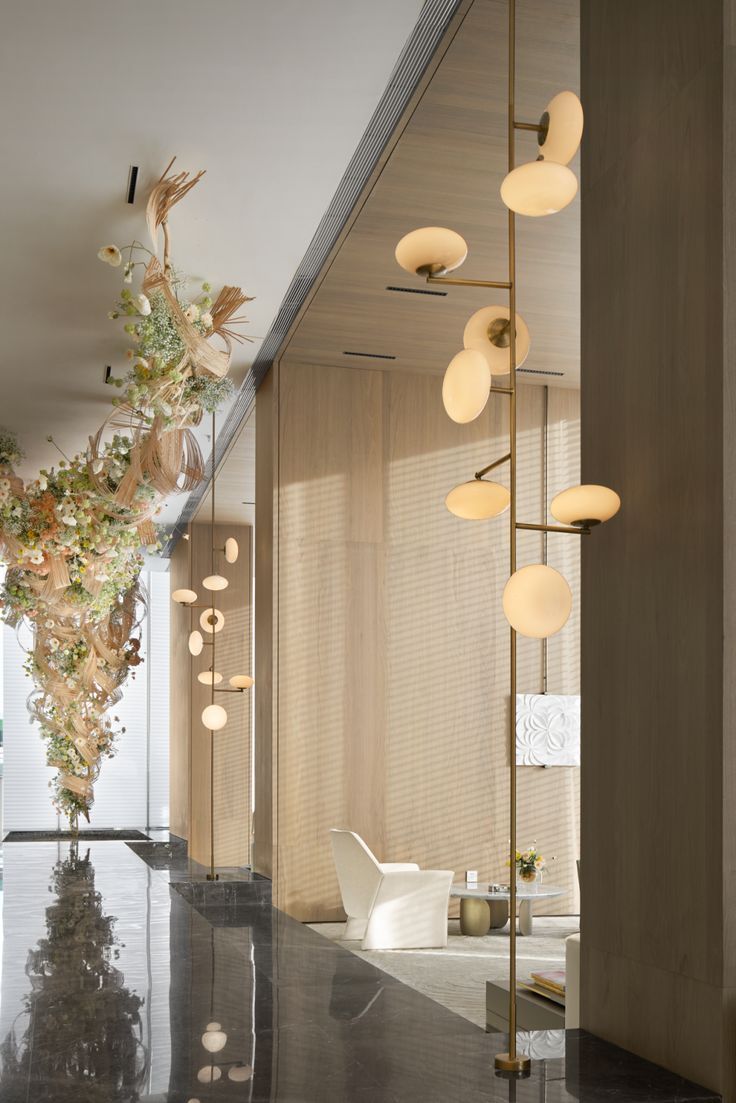 an elegant room with modern lighting and flowers in the vases on the side wall