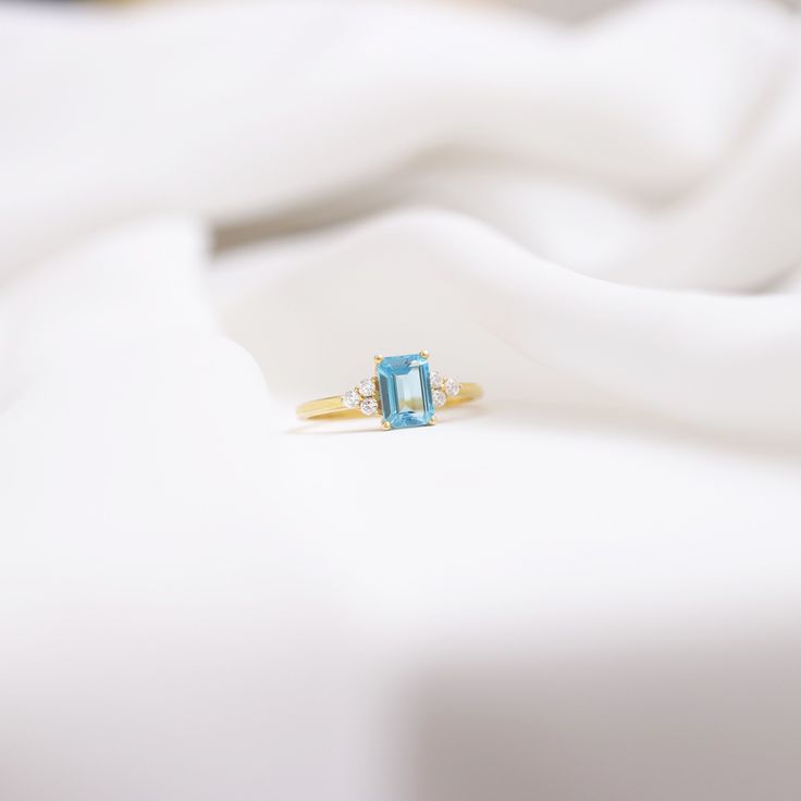 Your 14k Octagon Cut Swiss Blue Ring is stylish, dainty and pretty ideal for everyday use. Details of solid gold handmade Gold Swiss Blue Engagement Ring are very eye-catching. It is a great gift for your loved ones. This jewelry will be an indispensable piece of yours. This meaningful Gold December Birthstone Ring with high quality handwork will be a legacy you can leave to your family its. * Natural Swiss Blue Topaz Ring Details * Material / Gold Kt : This elegant ring is made of 14k and 18k S Blue Emerald-cut Diamond Ring With Birthstone, Blue Birthstone Ring With Diamond Accents For Gift, Blue Promise Rings With Diamond Accents, Light Blue Diamond Ring With Accent Stones For Wedding, Blue Emerald Cut Birthstone Ring, Blue Birthstone Ring With Emerald Cut, Aquamarine Rings With Diamond Accents For Wedding, Blue Emerald-cut Birthstone Ring As A Gift, Blue Emerald Cut Diamond Ring With Birthstone