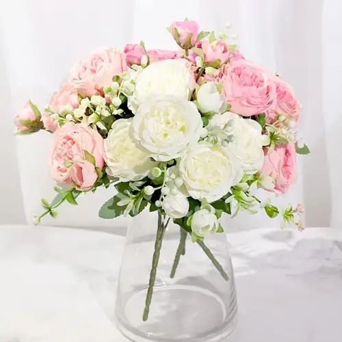 a clear vase filled with pink and white flowers