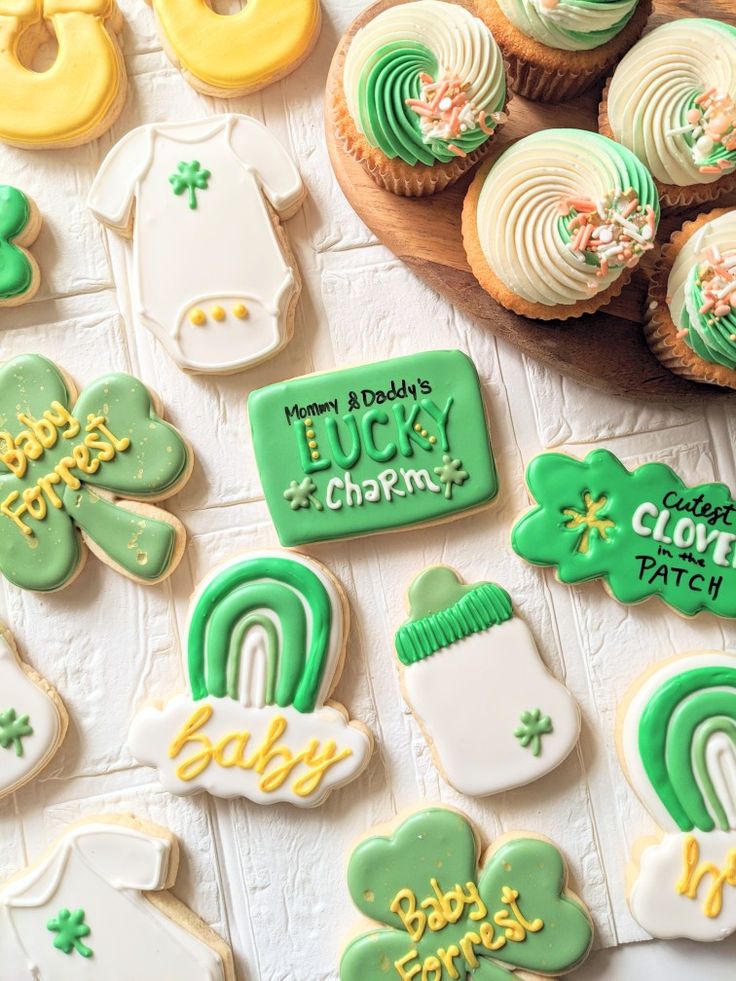 many decorated cookies on a table with green and white icing, including shamrocks, st patrick's day