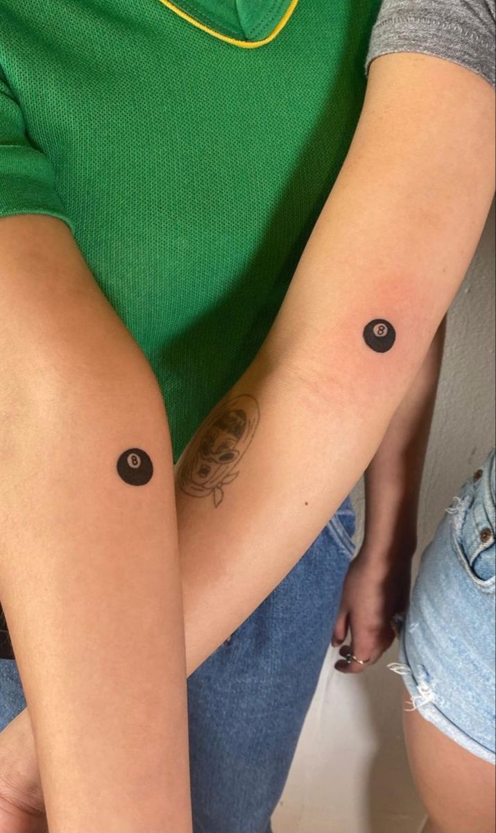 two people with matching tattoos on their arms