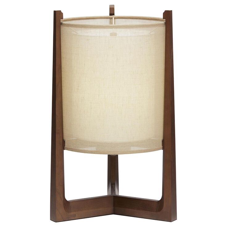 a wooden table lamp with a white shade on it's side and a brown base