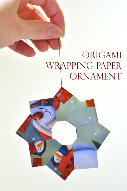 an origami hanging paper ornament is being held by someone's hand