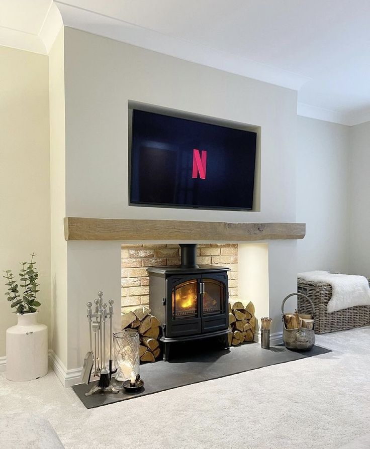 a living room with a fireplace and tv above it