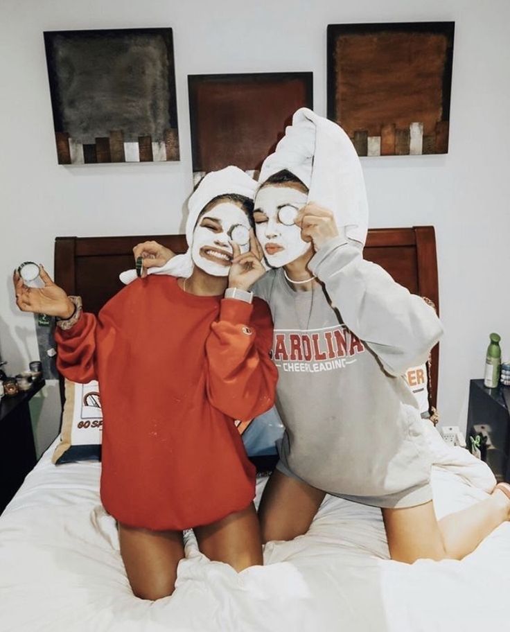 two people with their faces painted like they are sitting on a bed