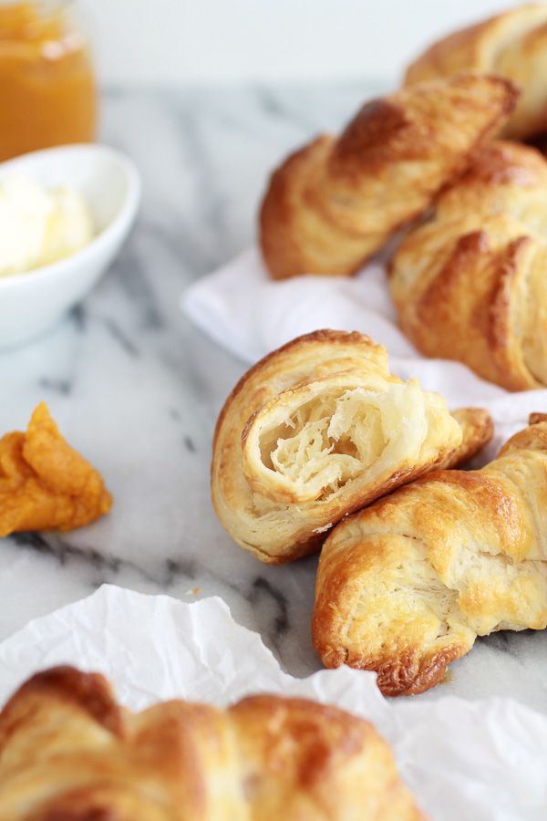 some croissants sitting on top of white paper