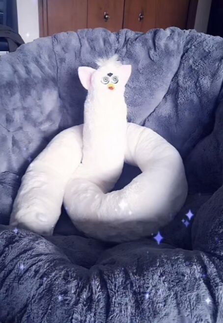 a stuffed animal sitting on top of a pillow