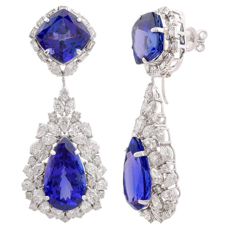 Cast from 18-karat gold, these exquisite earrings are handset with 61.61 carats tanzanite & 11.40 carats of sparkling diamonds. FOLLOW SPECTRUM JEWELS storefront to view the latest collection & exclusive pieces. Spectrum Jewels is proudly rated as a Top Seller on 1stDibs with 5 star customer reviews. All items manufactured by us are handmade and can be customized or redesigned. Item Code:- SEE-11728 Gross Wt :- 37.98 gm 18k Solid White Gold Wt :- 23.380 gm Natural Diamond Wt :- 11.400 ct. ( AVER White Gold Drop Earrings, Elegant Jewellery, Beautiful Tiaras, Diamond Dangle Earrings, Gemstone Stud Earrings, Tanzanite Gemstone, Natural Tanzanite, White Gold Jewelry, Gold Drop Earrings