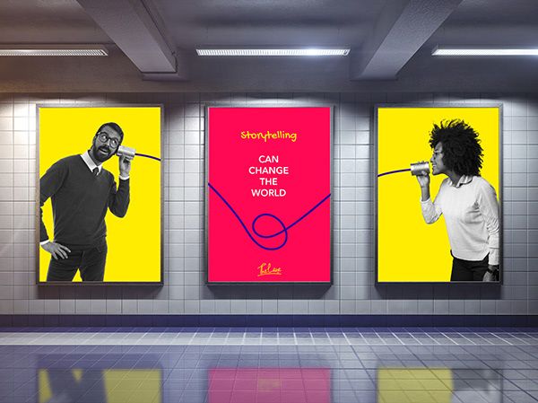 three posters on the wall in an empty room, one with a woman holding a microphone