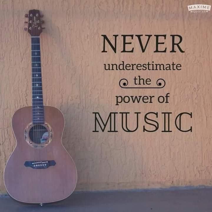 an acoustic guitar leaning against a wall with the words never underestimate at the 6 power of music